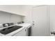 Functional laundry room equipped with modern washer and dryer units at 12355 W Hadley St, Avondale, AZ 85323