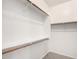 Walk-in closet with built-in shelves and rods for ample storage space at 12355 W Hadley St, Avondale, AZ 85323
