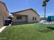 Artificial turf yard featuring patio, climbing structure, and partial privacy fence at 12938 W Alvarado Rd, Avondale, AZ 85392