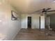 Bedroom featuring wood floor, ceiling fan, art, and ensuite bath at 12938 W Alvarado Rd, Avondale, AZ 85392