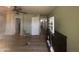 Bedroom featuring wood flooring, vanity, and several doorways at 12938 W Alvarado Rd, Avondale, AZ 85392
