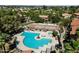 Aerial view of pool, tennis court and spa surrounded by mature landscaping at 1351 N Pleasant Dr # 1012, Chandler, AZ 85225