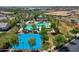 Stunning aerial view of community amenities including a pool, basketball court, playground, and lush landscaping at 14160 W Georgia Dr, Surprise, AZ 85379
