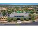 Wide aerial shot of community clubhouse surrounded by manicured lawns and residential homes at 14160 W Georgia Dr, Surprise, AZ 85379