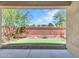 The backyard patio with artificial grass and a brick wall is ready for entertaining at 14160 W Georgia Dr, Surprise, AZ 85379