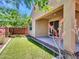 This backyard offers a stucco wall, desert plants and foliage and an artifical lawn with a covered patio at 14160 W Georgia Dr, Surprise, AZ 85379