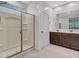 Modern bathroom featuring a glass enclosed shower, tile floors, and double sinks at 14160 W Georgia Dr, Surprise, AZ 85379