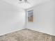 This bedroom is bright and airy and includes a ceiling fan and a window at 14160 W Georgia Dr, Surprise, AZ 85379