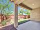 A serene covered patio overlooks a well-maintained backyard, perfect for outdoor relaxation at 14160 W Georgia Dr, Surprise, AZ 85379