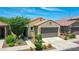 Charming single-Gathering home featuring a neutral-toned facade, low maintenance landscape, and an attached two-car garage at 14160 W Georgia Dr, Surprise, AZ 85379
