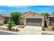 Charming single-Gathering home featuring a neutral-toned facade, low maintenance landscape, and an attached two-car garage at 14160 W Georgia Dr, Surprise, AZ 85379