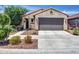 Charming single-Gathering home featuring a neutral-toned facade, low maintenance landscape, and an attached two-car garage at 14160 W Georgia Dr, Surprise, AZ 85379
