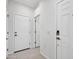 Bright hallway featuring neutral paint, tile floors, and a door with an electronic lock at 14160 W Georgia Dr, Surprise, AZ 85379