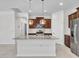 Open-concept kitchen featuring a large island with granite countertops and stainless-steel appliances at 14160 W Georgia Dr, Surprise, AZ 85379