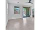 Bright living room with tiled floors, large windows and sliding glass door leading to the outdoor area at 14160 W Georgia Dr, Surprise, AZ 85379