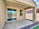 This covered back patio features a ceiling fan and easy access from the house at 14160 W Georgia Dr, Surprise, AZ 85379
