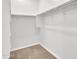 A bright walk-in closet with ample shelving and rod space for organized storage at 14160 W Georgia Dr, Surprise, AZ 85379