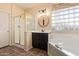 Bathroom featuring walk-in shower, soaking tub, dual sinks, and modern fixtures at 14895 W Jenan Dr, Surprise, AZ 85379