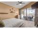 Bright bedroom featuring a ceiling fan and sliding glass doors opening to a patio at 14895 W Jenan Dr, Surprise, AZ 85379