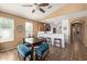Stylish dining area with bar seating, wooden table and neutral wall paint at 14895 W Jenan Dr, Surprise, AZ 85379