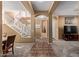 Spacious foyer with staircase, tile accents, and neutral color palette at 14895 W Jenan Dr, Surprise, AZ 85379