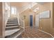 Grand foyer with high ceilings, staircase, and tile flooring at 14895 W Jenan Dr, Surprise, AZ 85379