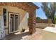 Home featuring a welcoming front porch with stone accents and desert landscaping at 14895 W Jenan Dr, Surprise, AZ 85379