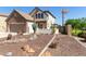 Charming two-story home featuring desert landscaping, a stone facade, and a two-car garage at 14895 W Jenan Dr, Surprise, AZ 85379