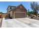 Home exterior showcasing a two-car garage with ample driveway space at 14895 W Jenan Dr, Surprise, AZ 85379