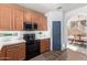 Well-lit kitchen features wooden cabinets and modern black appliances at 14895 W Jenan Dr, Surprise, AZ 85379