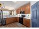 Modern kitchen with wood cabinets, quartz countertops, and stainless steel appliances at 14895 W Jenan Dr, Surprise, AZ 85379