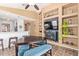 Open-concept living room with built-in shelving, a cozy seating area, and ample lighting at 14895 W Jenan Dr, Surprise, AZ 85379