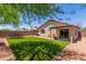 Private backyard boasts lush green turf, a covered patio, and ample space for outdoor entertaining at 14919 W Hearn Cir, Surprise, AZ 85379