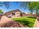 Large backyard featuring new grass, a patio area, and desert landscaping at 14919 W Hearn Cir, Surprise, AZ 85379