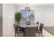 Bright dining room with a modern chandelier and a large window for natural light at 14919 W Hearn Cir, Surprise, AZ 85379