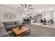 Open-concept living area with stylish furnishings and seamless flow into the kitchen and dining area at 14919 W Hearn Cir, Surprise, AZ 85379