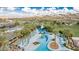 Overhead view of the community pool with slides, lounge chairs, and desert landscaping at 16373 W Beautiful Ln, Goodyear, AZ 85338