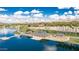 Aerial view of the community boat house and dock on the lake with beautiful landscaping at 16373 W Beautiful Ln, Goodyear, AZ 85338