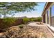 Large backyard area with desert landscaping and block wall at 16373 W Beautiful Ln, Goodyear, AZ 85338