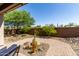 Backyard featuring desert landscaping and a brick patio at 16373 W Beautiful Ln, Goodyear, AZ 85338