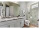Granite vanity top, double sinks and walk-in glass shower highlight the remodeled bathroom at 16373 W Beautiful Ln, Goodyear, AZ 85338
