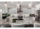 A close-up of the kitchen island featuring granite countertop, stainless appliances, and pendant lighting at 16373 W Beautiful Ln, Goodyear, AZ 85338