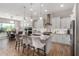 Beautiful kitchen with white cabinetry, granite countertops, a large island, and pendant lighting at 16373 W Beautiful Ln, Goodyear, AZ 85338
