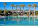 Beautiful community pool featuring lounge chairs and sun umbrellas for a relaxing atmosphere at 16373 W Beautiful Ln, Goodyear, AZ 85338