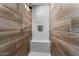 Walk-in shower with wood tile, a built-in bench, and niche for soaps and shampoos at 16373 W Beautiful Ln, Goodyear, AZ 85338