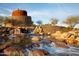 Decorative water feature with stone tower located in Estrella community at 16373 W Beautiful Ln, Goodyear, AZ 85338