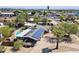 This aerial shot showcases a home with a pool and solar panels in a vibrant neighborhood at 1749 W Monterosa St, Phoenix, AZ 85015