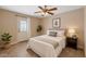 Cozy bedroom with a comfortable bed, stylish ceiling fan, and a convenient door to the outside at 1749 W Monterosa St, Phoenix, AZ 85015