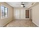 Neutral bedroom featuring tile floors, a window, ceiling fan, and dual closets at 1749 W Monterosa St, Phoenix, AZ 85015