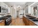 Spacious kitchen with tile floors, granite counters, and stainless steel appliances at 1749 W Monterosa St, Phoenix, AZ 85015